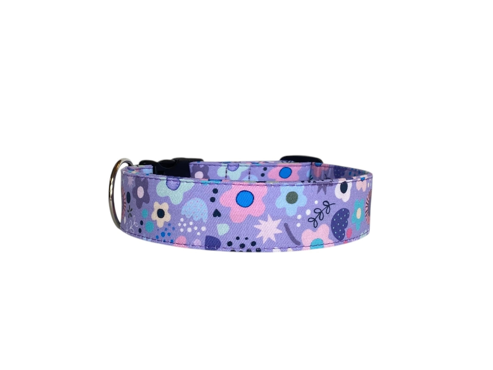 This charming dog collar features a whimsical purple background adorned with a delightful array of pastel floral and abstract patterns. The soft, dreamy colors make it a perfect accessory for stylish pups who love to stand out. 
For a personal touch, the collar can be customized with embroidered text, such as your dog's name, and the buckle can be engraved with important details, combining style and functionality. It's a unique and practical choice for your furry companion!