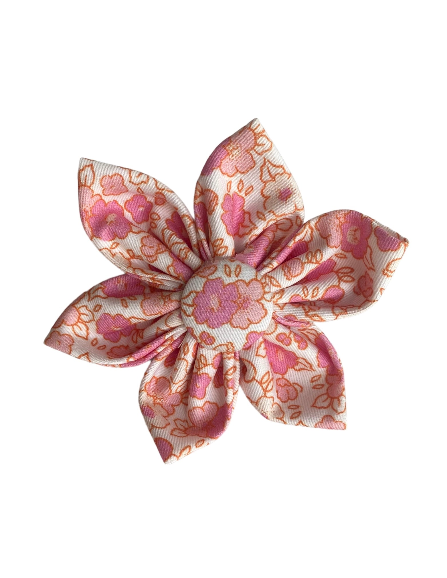 A cream dog collar flower with a lovely pink floral print.