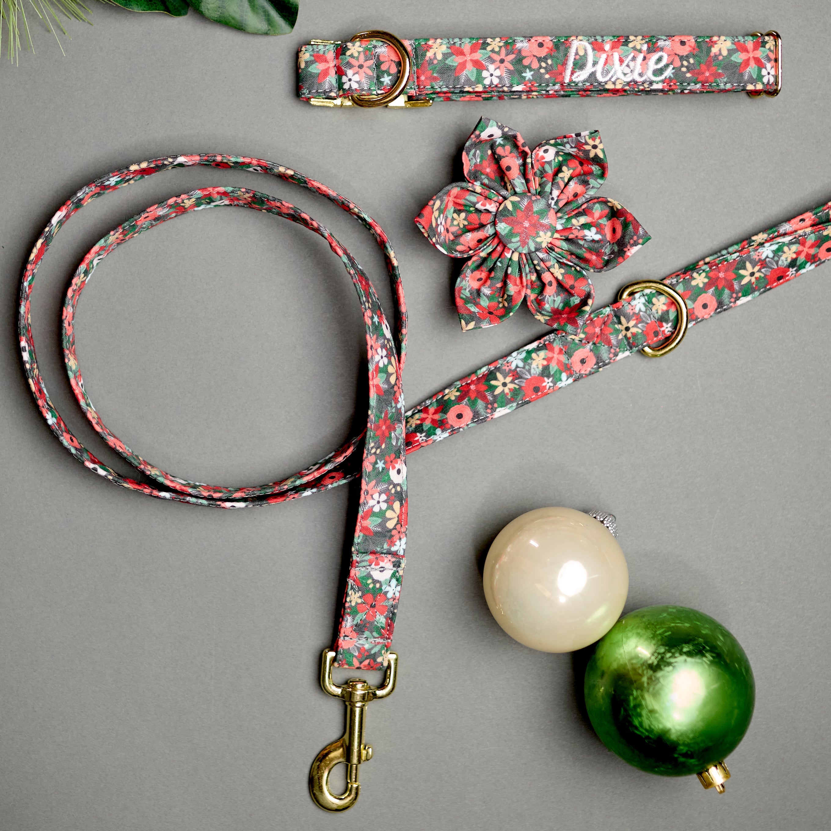 Whether choosing from a traditional dog collar, embroidered dog collar, or engraved buckle dog collar, you’ll find a great selection of personalized dog collars to choose from.  Duke & Fox® personalized dog collars come in a variety of unique styles and patterns. Our embroidered collars and engraved buckle collars also add to your dog's safety and your peace of mind with critical contact information should you and your dog get separated.  Christmas floral dog collar with matching leash and flower.