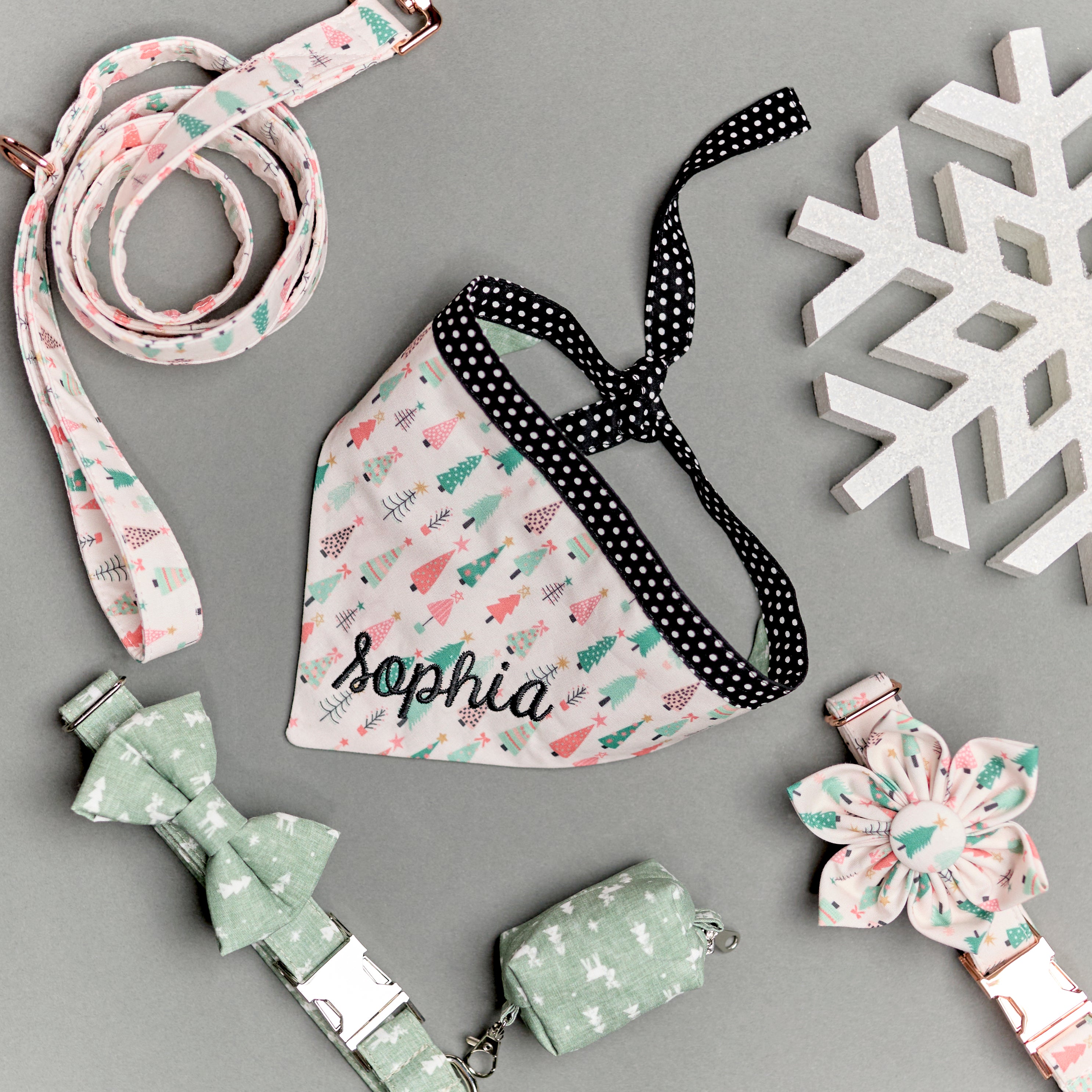 A personalized bandana by Duke & Fox is the perfect pet accessory that is customized with the pet's name. Bandanas that are double sided for more options. Christmas pink trees embroidered dog bandana. Matching collar, leash, and flower. Matching reindeer collar and bowtie.