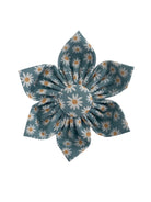 Blue dog collar flower with white daisies all over it. Features: 4" in size and can wrap around collars that are up to 2" in width, the Velcro® can also be trimmed to fit snuggly around smaller collars