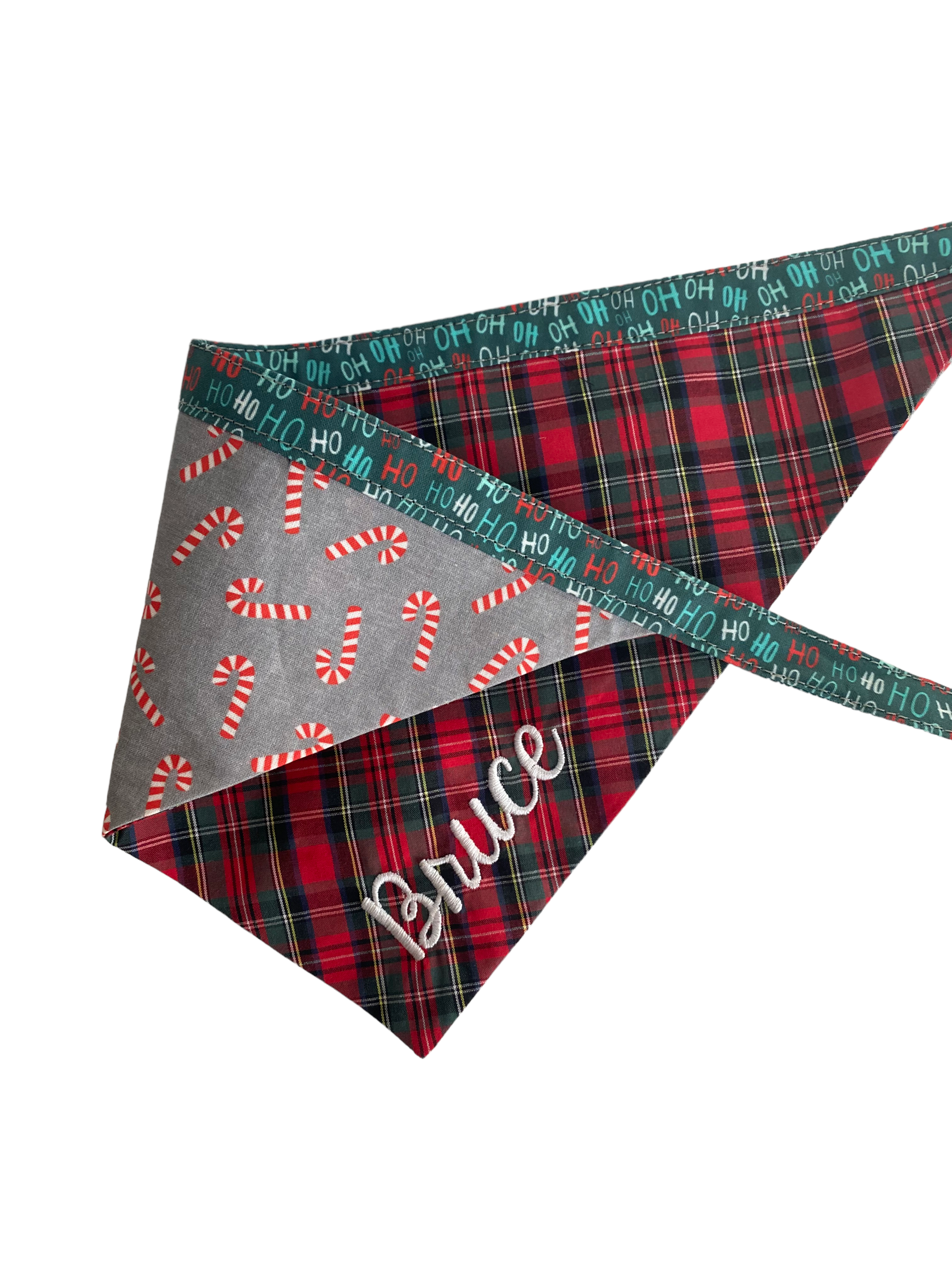A personalized bandana by Duke & Fox is the perfect pet accessory that is customized with the pet's name. Bandanas that are double sided for more options. Buffalo plaid embroidered dog bandana. Christmas candy cane embroidered dog bandana.