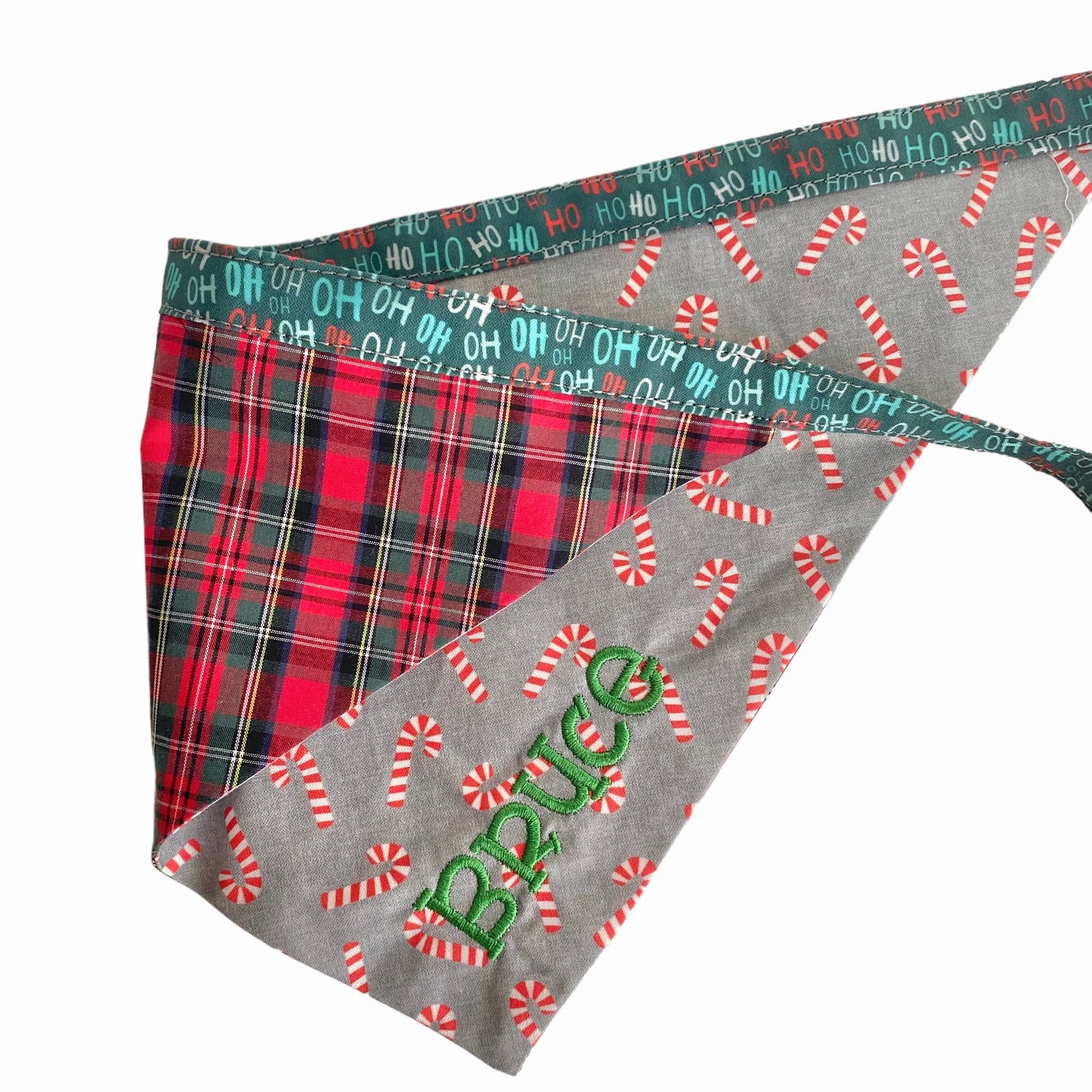 A personalized bandana by Duke & Fox is the perfect pet accessory that is customized with the pet's name. Bandanas that are double sided for more options. Christmas candy cane embroidered dog bandana. Buffalo plaid embroidered dog bandana.