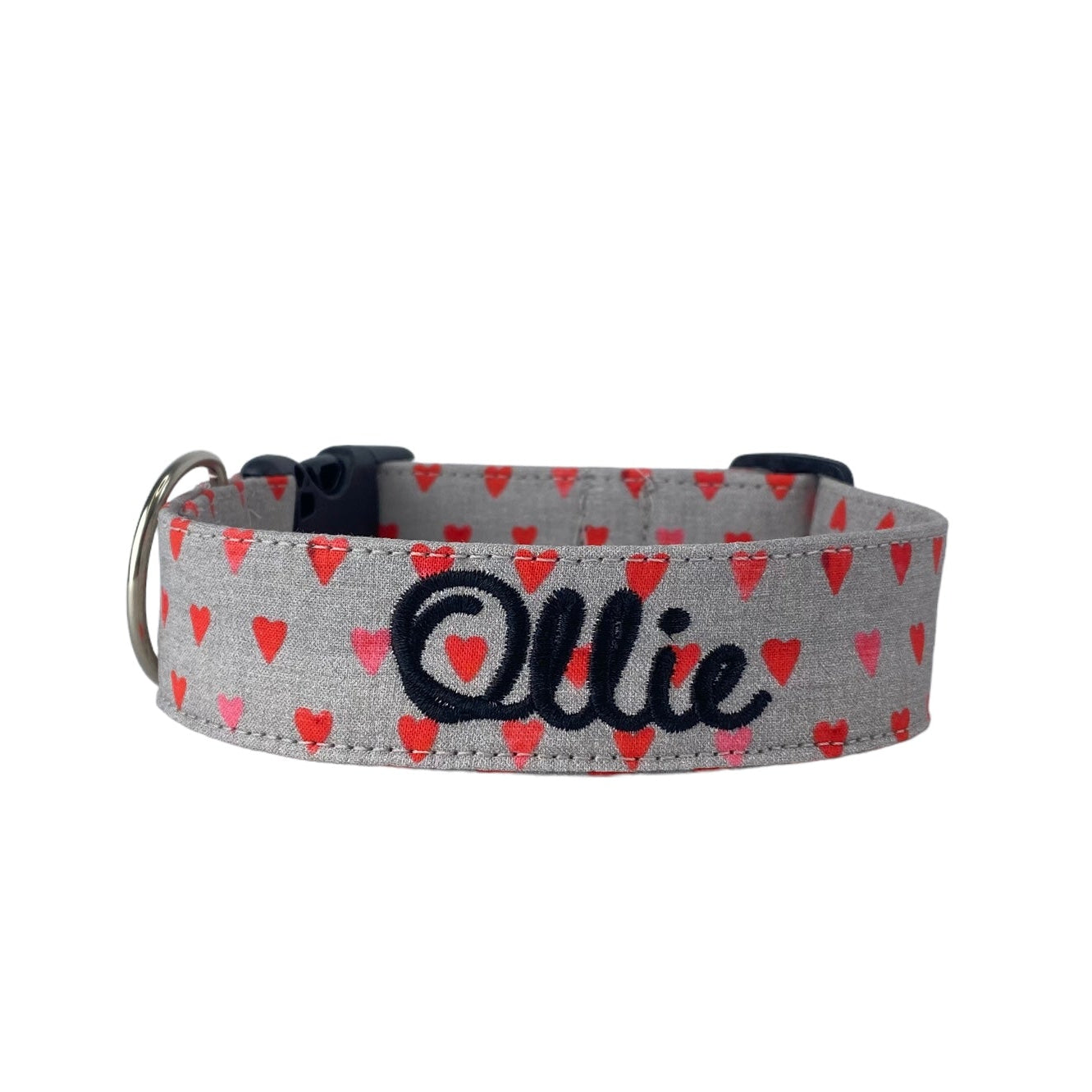 Whether choosing from a traditional dog collar, embroidered dog collar, or engraved buckle dog collar, you’ll find a great selection of personalized dog collars to choose from.  Duke & Fox® personalized dog collars come in a variety of unique styles and patterns. Our embroidered collars and engraved buckle collars also add to your dog's safety and your peace of mind with critical contact information should you and your dog get separated.  Valentine's Day gray dog collar with red and pink hearts.