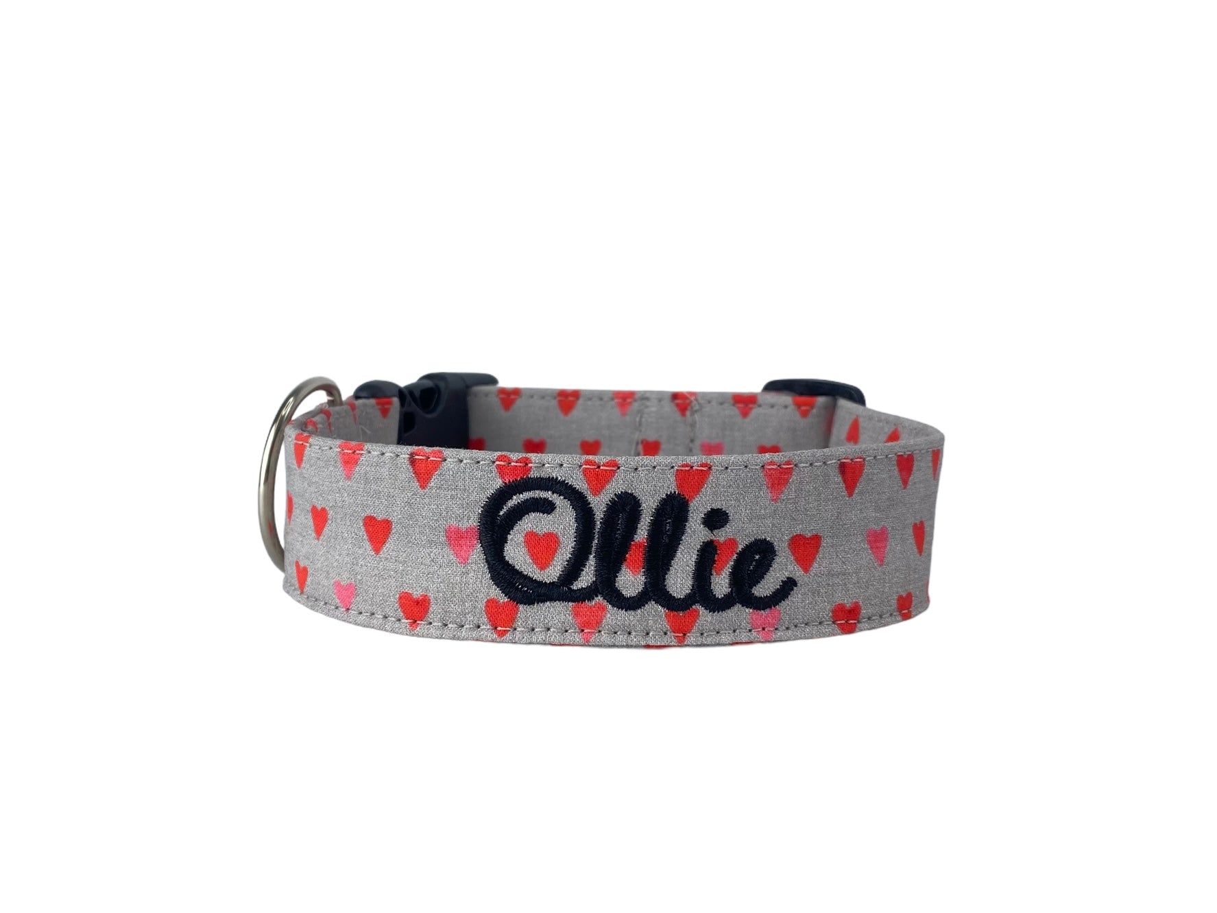 Whether choosing from a traditional dog collar, embroidered dog collar, or engraved buckle dog collar, you’ll find a great selection of personalized dog collars to choose from.  Duke & Fox® personalized dog collars come in a variety of unique styles and patterns. Our embroidered collars and engraved buckle collars also add to your dog's safety and your peace of mind with critical contact information should you and your dog get separated.  Valentine's Day gray dog collar with red and pink hearts.