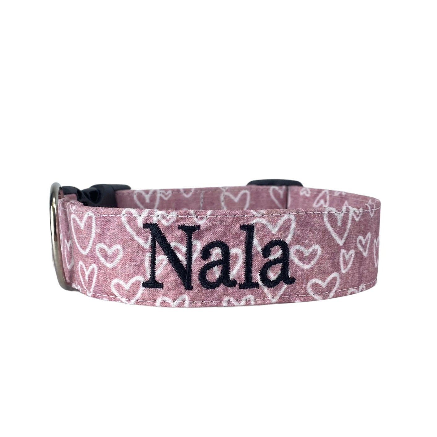 Personalized Valetine's Day Dog Collar by Duke & Fox. A dusty rose colored dog collar with white hearts and an embroidered name in black thread. Duke & Fox personalized dog collars can be embroidered and/or offered with an engraved buckle in many color choices.