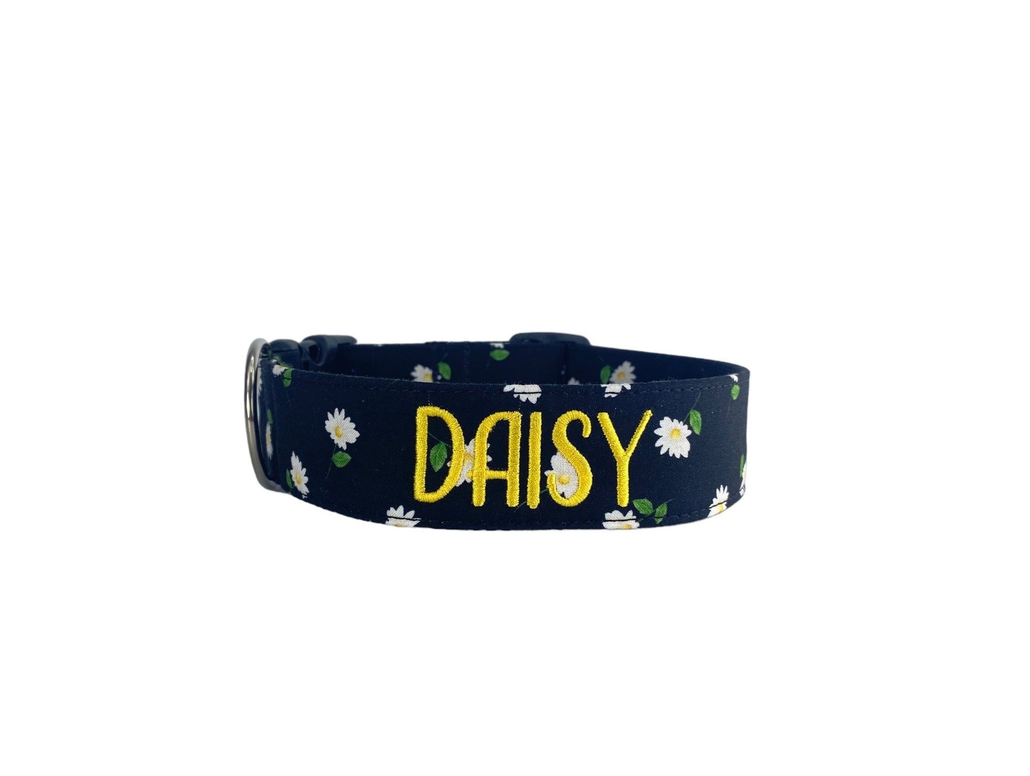 Whether choosing from a traditional dog collar, embroidered dog collar, or engraved buckle dog collar, you’ll find a great selection of personalized dog collars to choose from.  Duke & Fox® personalized dog collars come in a variety of unique styles and patterns. Our embroidered collars and engraved buckle collars also add to your dog's safety and your peace of mind with critical contact information should you and your dog get separated.  Black dog collar with white daisies.