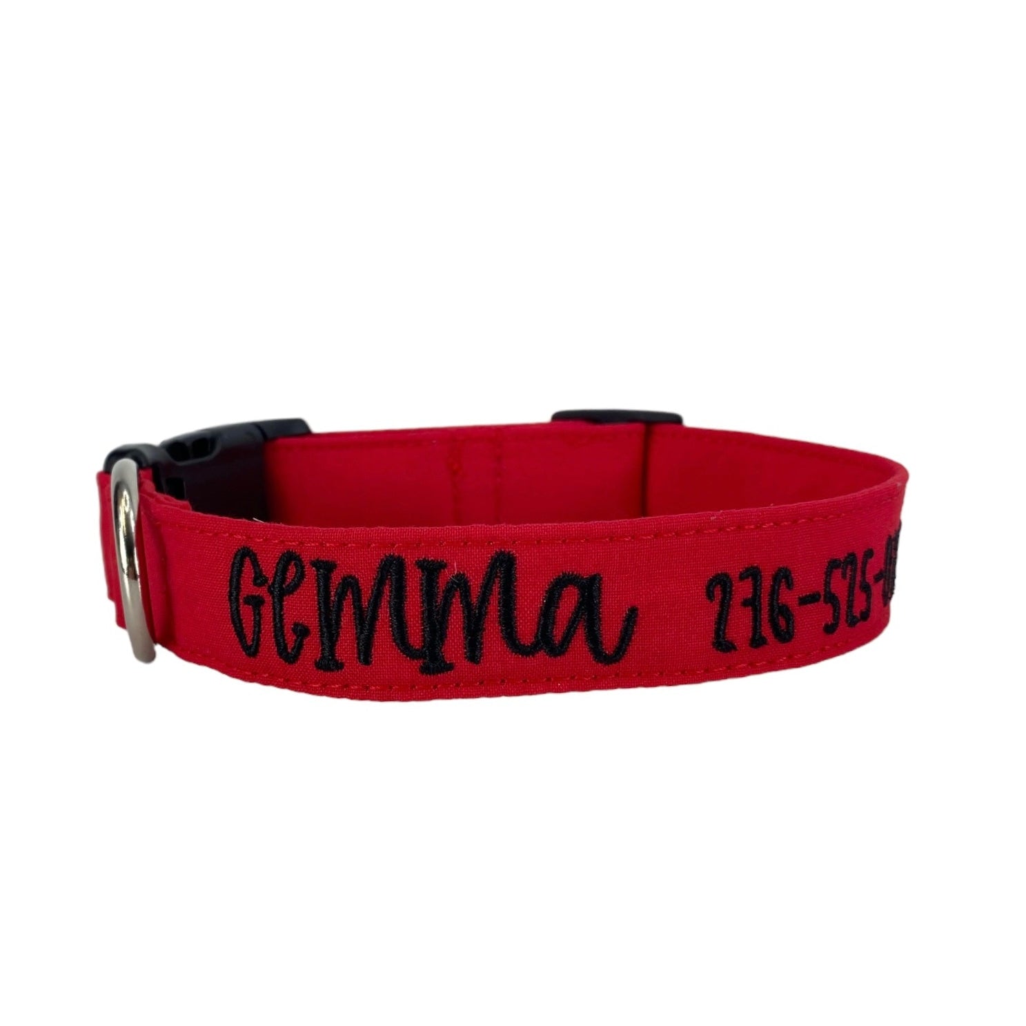 A plain red dog collar showcasing the name Gemma embroidered on the side.