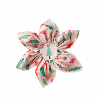 a dog collar flower with Cute girly christmas trees with soft greens, reds and pinks on a pale pink back drop.
