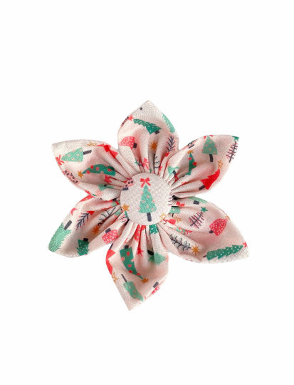 a dog collar flower with Cute girly christmas trees with soft greens, reds and pinks on a pale pink back drop.
