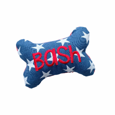 A blue one shaped dog toy with the name Bash embroidered on the front to showcase a personalized example.