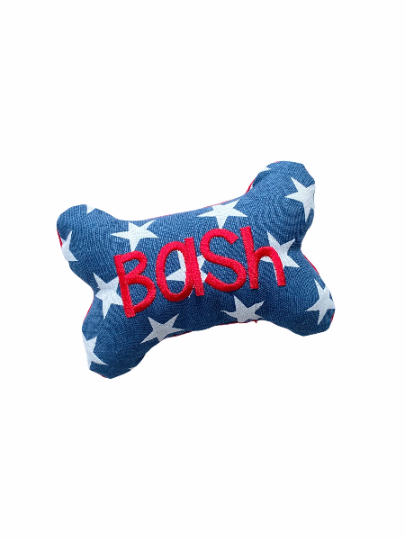 A blue one shaped dog toy with the name Bash embroidered on the front to showcase a personalized example.