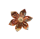 Rustic floral dog collar flower accessory with burnt orange background and yellow, pale blue floral designs.