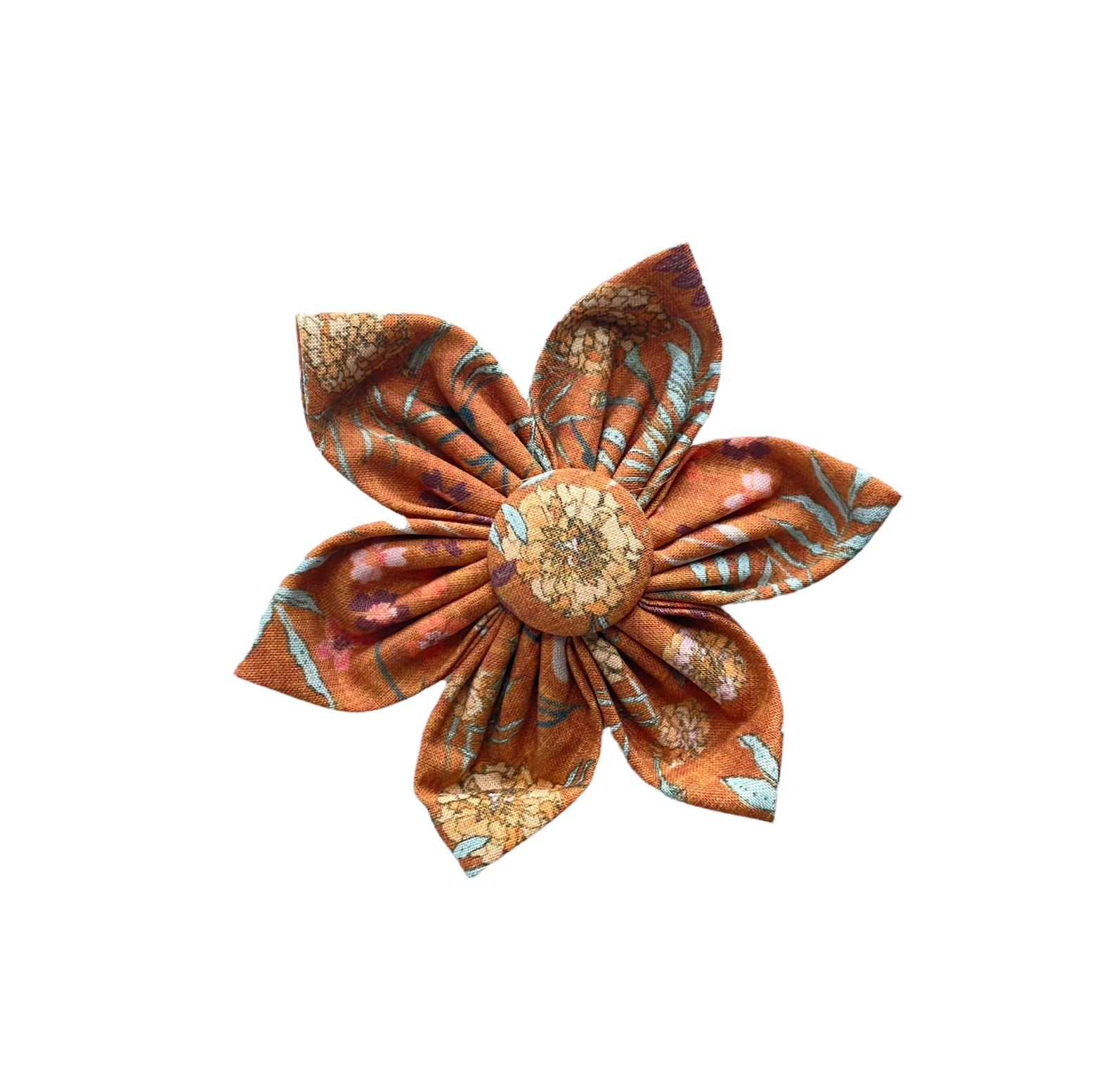 Rustic floral dog collar flower accessory with burnt orange background and yellow, pale blue floral designs.