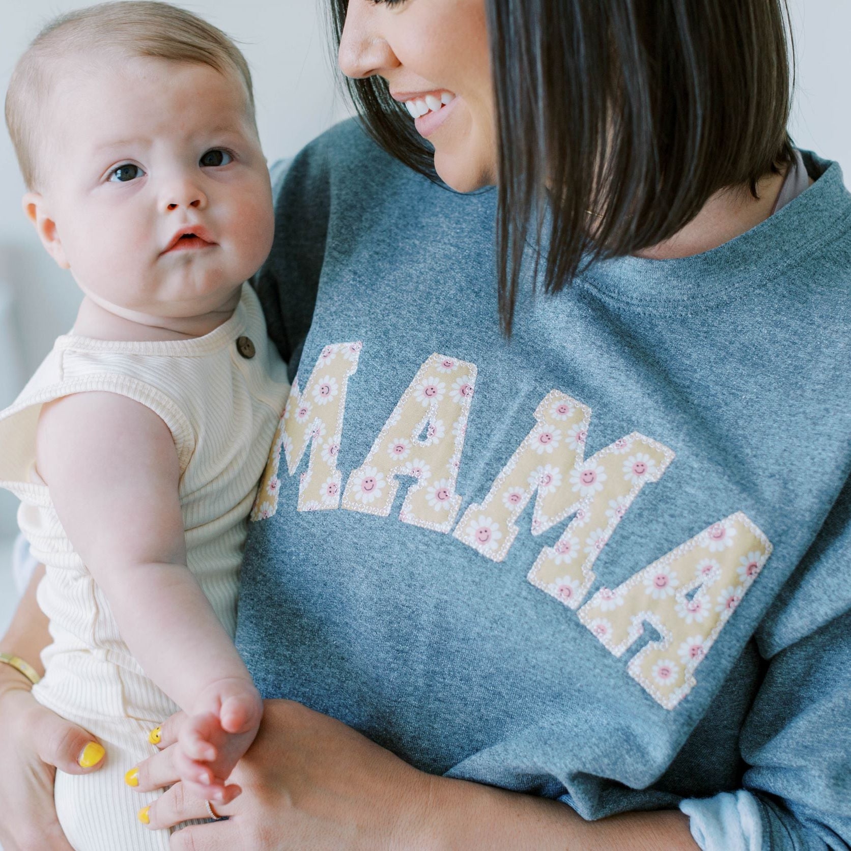 Mama Sweatshirt worn by model holding baby.