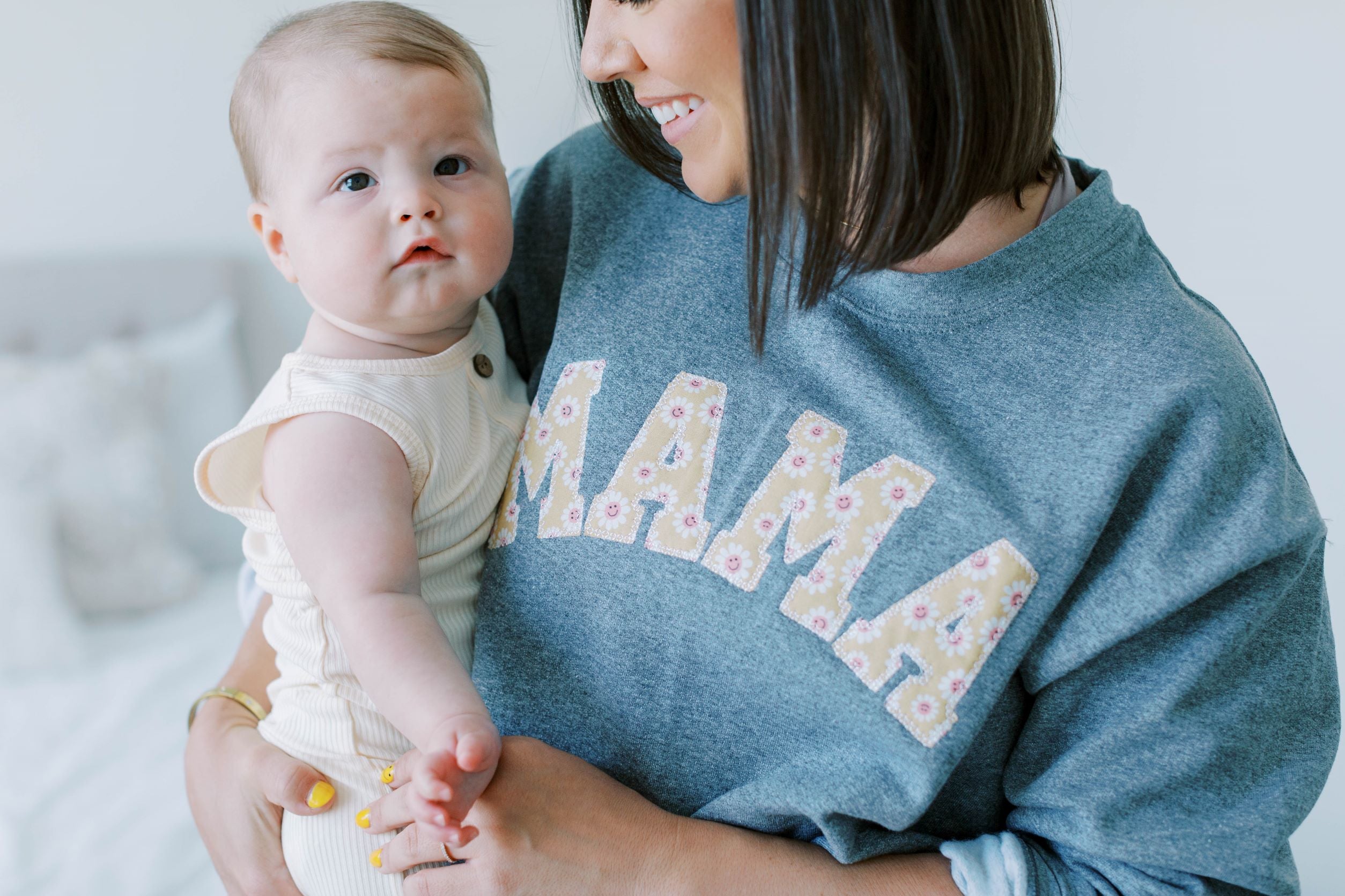 Mama Sweatshirt worn by model holding baby.
