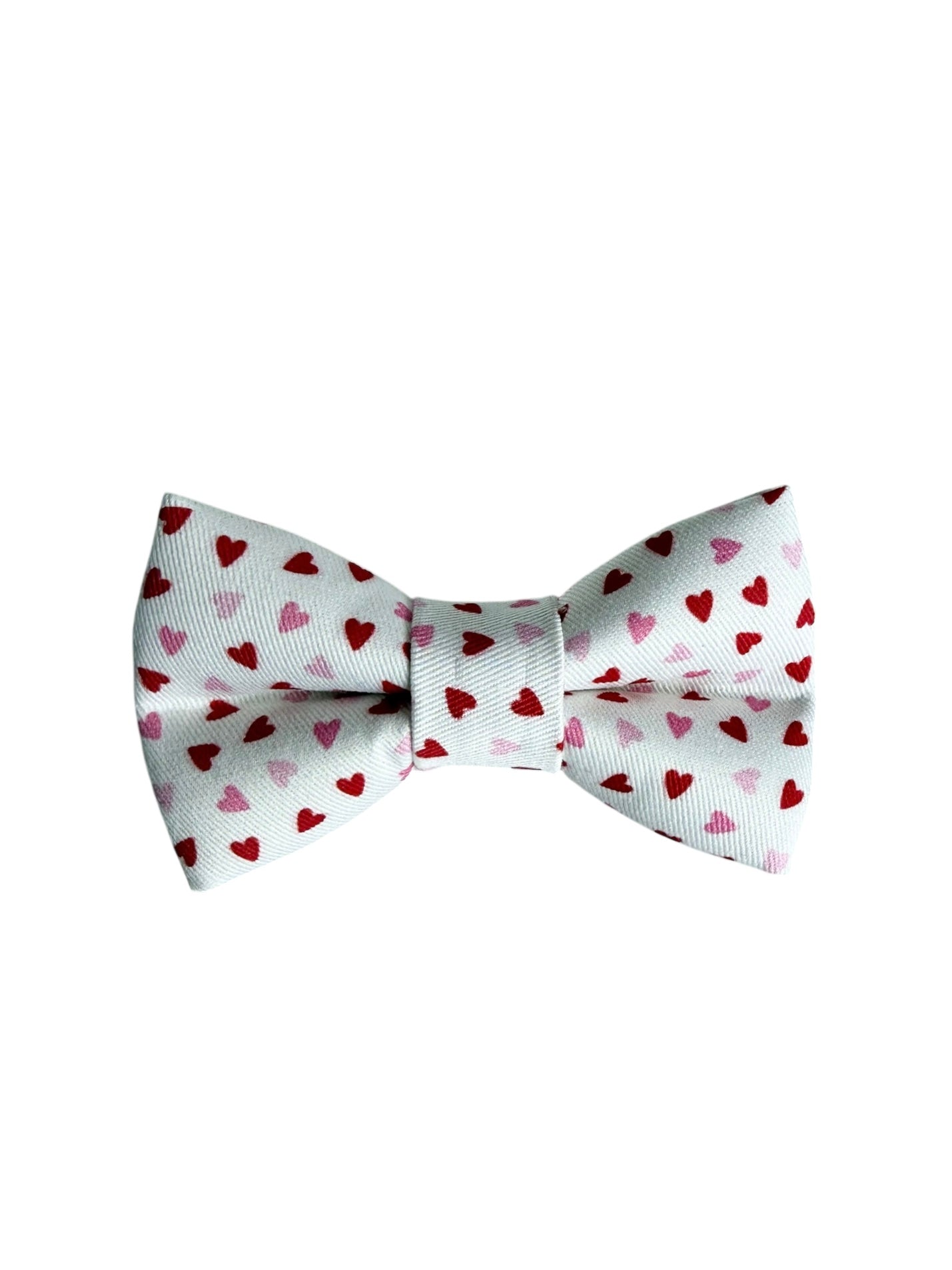 White bow tie with red and pink heart patterns on a white background.  Adjustable with velcro.  Custom dog bow tie by Duke & Fox.