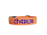 Whether choosing from a traditional dog collar, embroidered dog collar, or engraved buckle dog collar, you’ll find a great selection of personalized dog collars to choose from.  Duke & Fox® personalized dog collars come in a variety of unique styles and patterns. Our embroidered collars and engraved buckle collars also add to your dog's safety and your peace of mind with critical contact information should you and your dog get separated.  Orange gingham dog collar. 