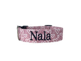 Personalized Valetine's Day Dog Collar by Duke & Fox. A dusty rose colored dog collar with white hearts and an embroidered name in black thread. Duke & Fox personalized dog collars can be embroidered and/or offered with an engraved buckle in many color choices.