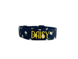 Whether choosing from a traditional dog collar, embroidered dog collar, or engraved buckle dog collar, you’ll find a great selection of personalized dog collars to choose from.  Duke & Fox® personalized dog collars come in a variety of unique styles and patterns. Our embroidered collars and engraved buckle collars also add to your dog's safety and your peace of mind with critical contact information should you and your dog get separated.  Black dog collar with white daisies. 